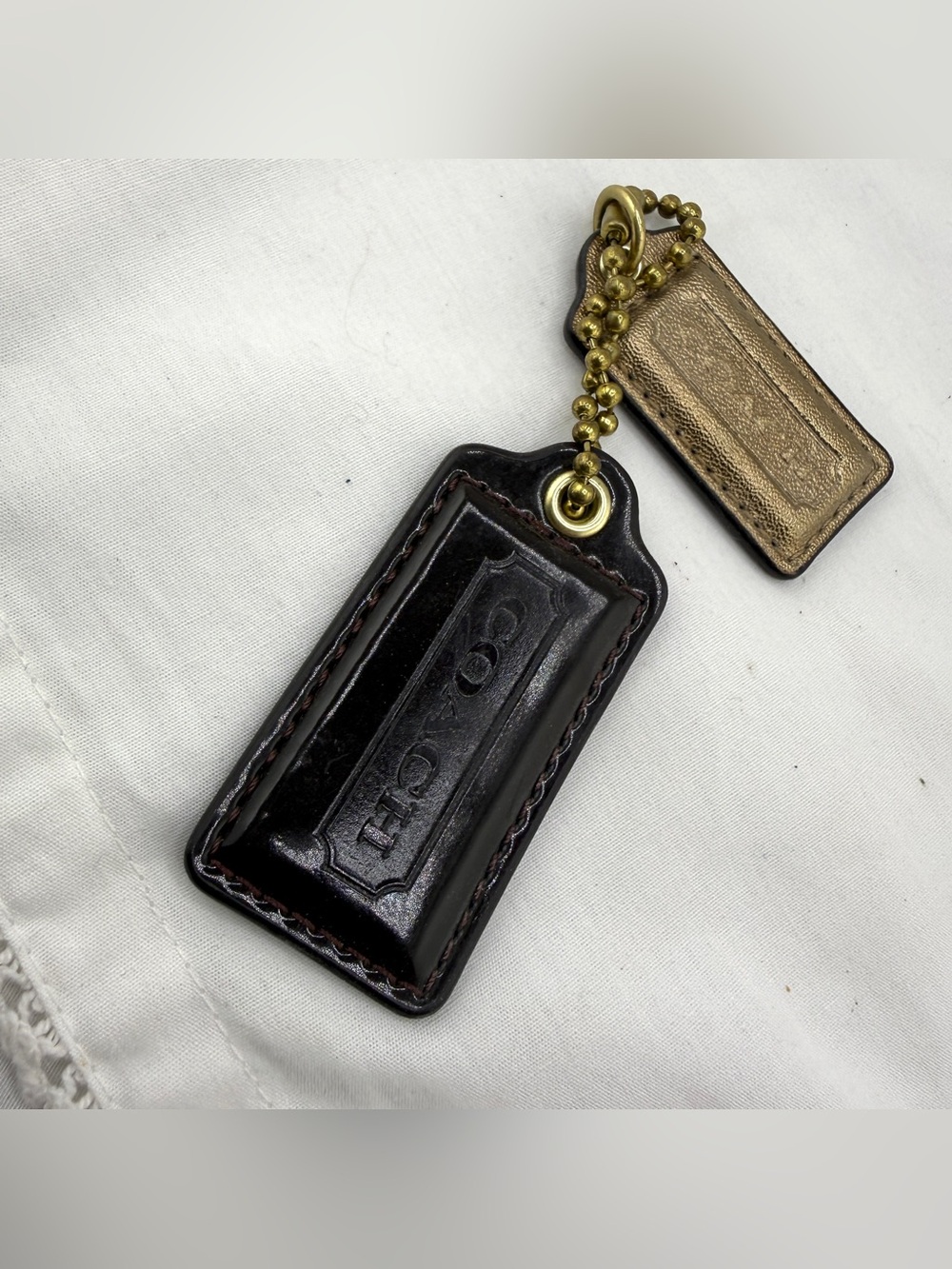 Coach purse tags. Maroon and gold.